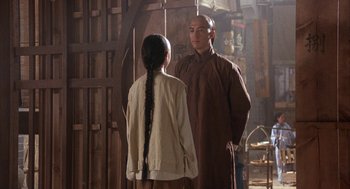 Movie still from “Iron Monkey” (1993), directed by Woo-Ping Yuen – A man and a woman standing next to each other; Medium shot, Over the shoulder angle