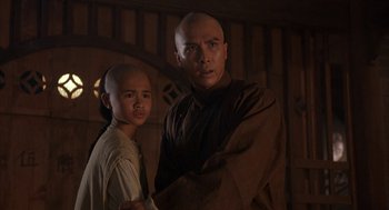 Movie still from “Iron Monkey” (1993), directed by Woo-Ping Yuen – A man and a young boy standing next to each other; Close Up shot, Over the shoulder angle