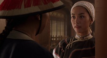 Movie still from “Iron Monkey” (1993), directed by Woo-Ping Yuen – A woman wearing a hat is talking to a man; Close Up shot, Over the shoulder angle