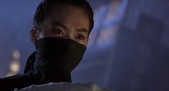 Movie still from “Iron Monkey” (1993), directed by Woo-Ping Yuen – A person wearing a black mask and looking at the camera; Close Up shot, Low angle