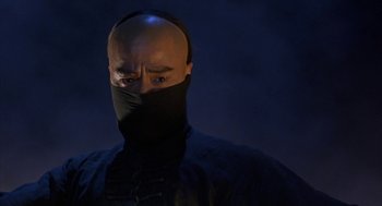 Movie still from “Iron Monkey” (1993), directed by Woo-Ping Yuen – A bald man with a black mask on his face; Close Up shot, Low angle