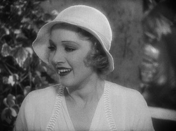 Movie still from “Island of Lost Souls” (1932), directed by Erle C. Kenton – An old photo of a woman wearing a white hat; Close Up shot, High angle
