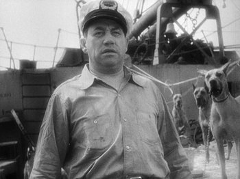 Movie still from “Island of Lost Souls” (1932), directed by Erle C. Kenton – An old black and white photo of a man wearing a hat; Medium shot, Low angle