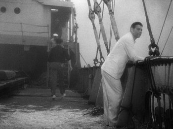 Movie still from “Island of Lost Souls” (1932), directed by Erle C. Kenton – A black and white photo of a man leaning against a wall; Wide shot, High angle