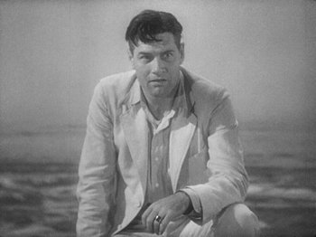 Movie still from “Island of Lost Souls” (1932), directed by Erle C. Kenton – A man sitting on the ground in front of a body of water; Close Up shot, High angle