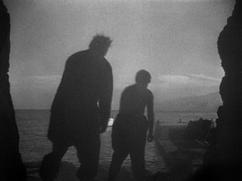 Movie still from “Island of Lost Souls” (1932), directed by Erle C. Kenton – Two people walking on a beach near the ocean; Extreme Wide shot, Low angle