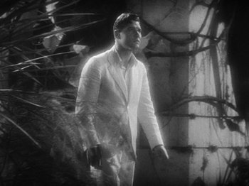 Movie still from “Island of Lost Souls” (1932), directed by Erle C. Kenton – A black and white photo of a man in a white suit; Medium shot, Low angle