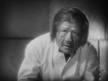 Movie still from “Island of Lost Souls” (1932), directed by Erle C. Kenton – An older man with long hair wearing a white coat; Close Up shot, Low angle