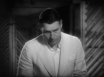 Movie still from “Island of Lost Souls” (1932), directed by Erle C. Kenton – A man in a white suit looking down at the ground; Close Up shot, High angle