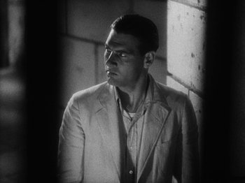 Movie still from “Island of Lost Souls” (1932), directed by Erle C. Kenton – Black and white photograph of a man wearing a suit; Medium shot, Low angle