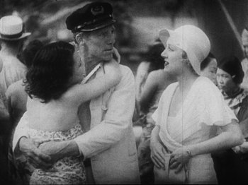 Movie still from “Island of Lost Souls” (1932), directed by Erle C. Kenton – An old photo of two women and an older man; Medium shot, High angle