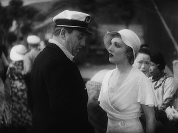 Movie still from “Island of Lost Souls” (1932), directed by Erle C. Kenton – An old photo of a man and a woman talking to each other; Medium shot, High angle