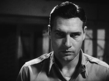 Movie still from “Island of Lost Souls” (1932), directed by Erle C. Kenton – Black and white photograph of a man in a military uniform; Close Up shot, Low angle