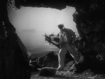 Movie still from “Island of Lost Souls” (1932), directed by Erle C. Kenton – A black and white photo of a man in a cave; Wide shot, High angle