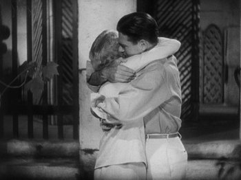 Movie still from “Island of Lost Souls” (1932), directed by Erle C. Kenton – A man and a woman hugging each other in a black and white photo; Medium shot, High angle