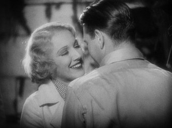 Movie still from “Island of Lost Souls” (1932), directed by Erle C. Kenton – An old photo of a man and a woman smiling at each other; Close Up shot, Over the shoulder angle