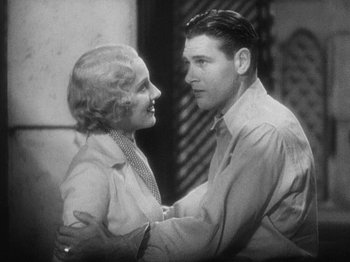 Movie still from “Island of Lost Souls” (1932), directed by Erle C. Kenton – An old photo of a man and a woman; Medium shot, High angle