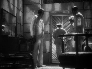 Movie still from “Island of Lost Souls” (1932), directed by Erle C. Kenton – A group of people standing in a room; Wide shot, High angle