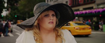 Movie still from “Isn't It Romantic” (2019), directed by Todd Strauss-Schulson – A person wearing a hat; Close Up shot, Over the shoulder angle