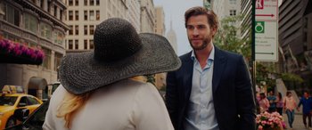 Movie still from “Isn't It Romantic” (2019), directed by Todd Strauss-Schulson – A man in a suit and a woman in a hat; Medium shot, Over the shoulder angle