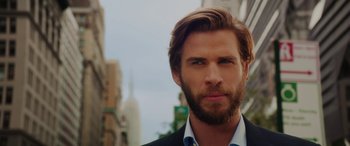 Movie still from “Isn't It Romantic” (2019), directed by Todd Strauss-Schulson – A person wearing a suit and tie; Close Up shot, Low angle