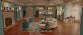 A living room filled with furniture next to a kitchen
