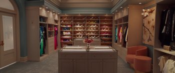 Movie still from “Isn't It Romantic” (2019), directed by Todd Strauss-Schulson – A room filled with lots of shoes and a counter; Wide shot, Overhead angle