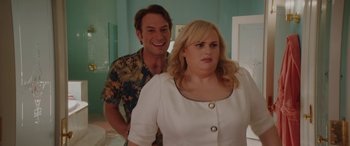 Movie still from “Isn't It Romantic” (2019), directed by Todd Strauss-Schulson – A man standing next to a woman in front of a mirror; Medium shot, Over the shoulder angle