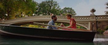 Movie still from “Isn't It Romantic” (2019), directed by Todd Strauss-Schulson – A man and a woman sitting in a boat on the water; Wide shot, High angle
