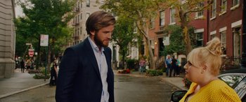 Movie still from “Isn't It Romantic” (2019), directed by Todd Strauss-Schulson – A man in a suit walking down the street; Medium shot, Over the shoulder angle