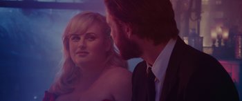 Movie still from “Isn't It Romantic” (2019), directed by Todd Strauss-Schulson – A man and a woman looking at one another in the mirror; Close Up shot, Over the shoulder angle