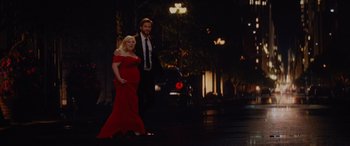Movie still from “Isn't It Romantic” (2019), directed by Todd Strauss-Schulson – A woman in a red dress and a man in a black suit; Wide shot, Over the shoulder angle