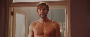 Movie still from “Isn't It Romantic” (2019), directed by Todd Strauss-Schulson – A man with no shirt in front of a bathroom mirror; Medium shot, Over the shoulder angle