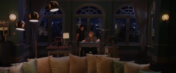 Movie still from “Isn't It Romantic” (2019), directed by Todd Strauss-Schulson – A man and a woman working at a computer desk in a living room; Wide shot, High angle