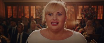 Movie still from “Isn't It Romantic” (2019), directed by Todd Strauss-Schulson – A person with blonde hair; Close Up shot, Over the shoulder angle