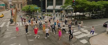 Movie still from “Isn't It Romantic” (2019), directed by Todd Strauss-Schulson – A group of people crossing the street in a crosswalk; Extreme Wide shot, High angle