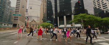 Movie still from “Isn't It Romantic” (2019), directed by Todd Strauss-Schulson – A group of people crossing the street in the middle of the street; Extreme Wide shot, High angle
