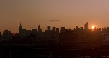 Movie still from “It Could Happen to You” (1994), directed by Andrew Bergman – A view of a city skyline at sunset; Extreme Wide shot, Low angle