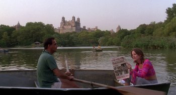 Movie still from “It Could Happen to You” (1994), directed by Andrew Bergman – A man and a woman in a row boat on a lake; Wide shot, Over the shoulder angle