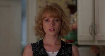 Movie still from “It Could Happen to You” (1994), directed by Andrew Bergman – A person wearing a dress; Close Up shot, Over the shoulder angle