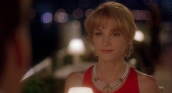 Movie still from “It Could Happen to You” (1994), directed by Andrew Bergman – A person wearing a necklace; Close Up shot, Over the shoulder angle