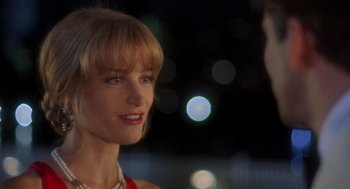 Movie still from “It Could Happen to You” (1994), directed by Andrew Bergman – A person wearing a necklace; Close Up shot, Over the shoulder angle