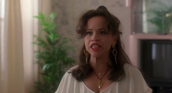 Movie still from “It Could Happen to You” (1994), directed by Andrew Bergman – A person wearing a white shirt; Close Up shot, Low angle