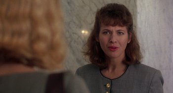 Movie still from “It Could Happen to You” (1994), directed by Andrew Bergman – A person looking at a mirror; Close Up shot, Over the shoulder angle