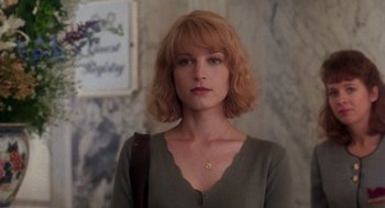 Movie still from “It Could Happen to You” (1994), directed by Andrew Bergman – A woman with red hair wearing a green shirt; Close Up shot, Low angle