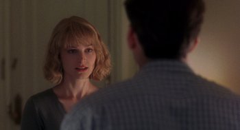 Movie still from “It Could Happen to You” (1994), directed by Andrew Bergman – A man and a woman looking at one another in a mirror; Close Up shot, Over the shoulder angle