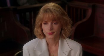 Movie still from “It Could Happen to You” (1994), directed by Andrew Bergman – A person wearing a white jacket; Close Up shot, Over the shoulder angle