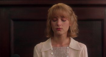 Movie still from “It Could Happen to You” (1994), directed by Andrew Bergman – A woman with her eyes closed is wearing a white shirt; Close Up shot, Low angle