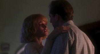 Movie still from “It Could Happen to You” (1994), directed by Andrew Bergman – A man and a woman standing next to each other; Close Up shot, Low angle