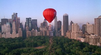 Movie still from “It Could Happen to You” (1994), directed by Andrew Bergman – A hot air balloon is flying over a city; Extreme Wide shot, High angle